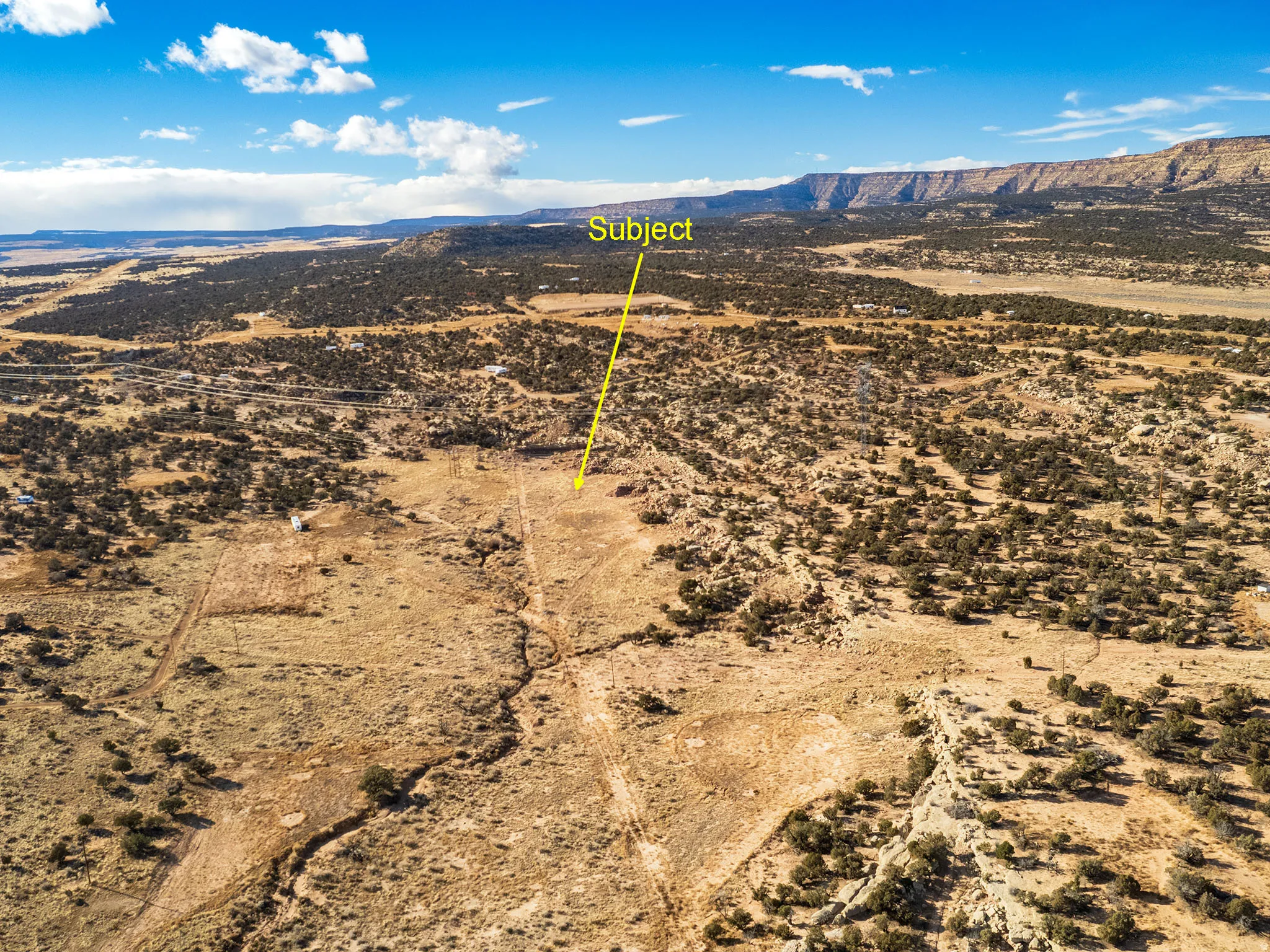Aerial view of sparsely populated area featuring a mountainous background and a desert landscape