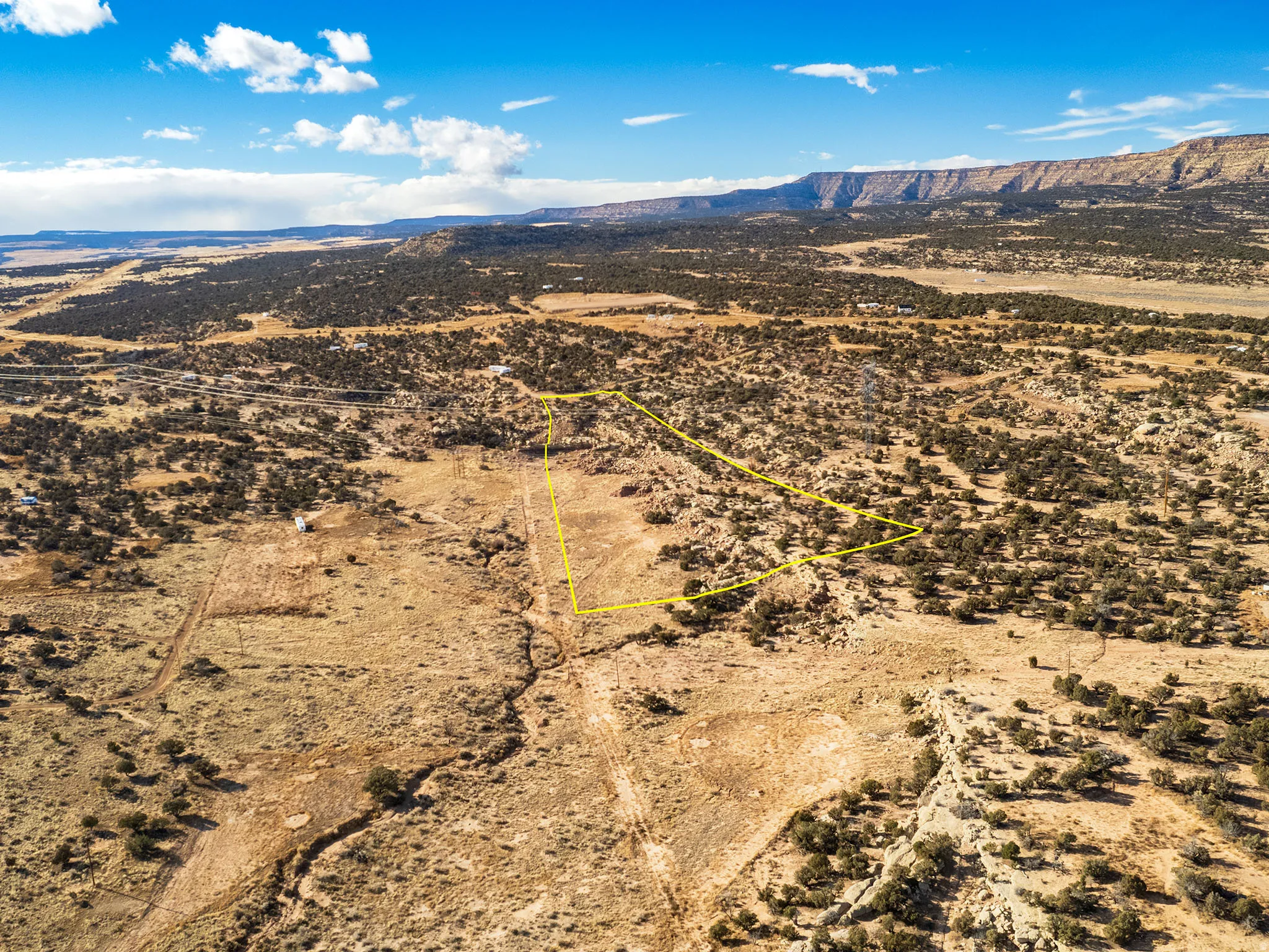 Aerial view of sparsely populated area featuring a mountain backdrop and a desert landscape