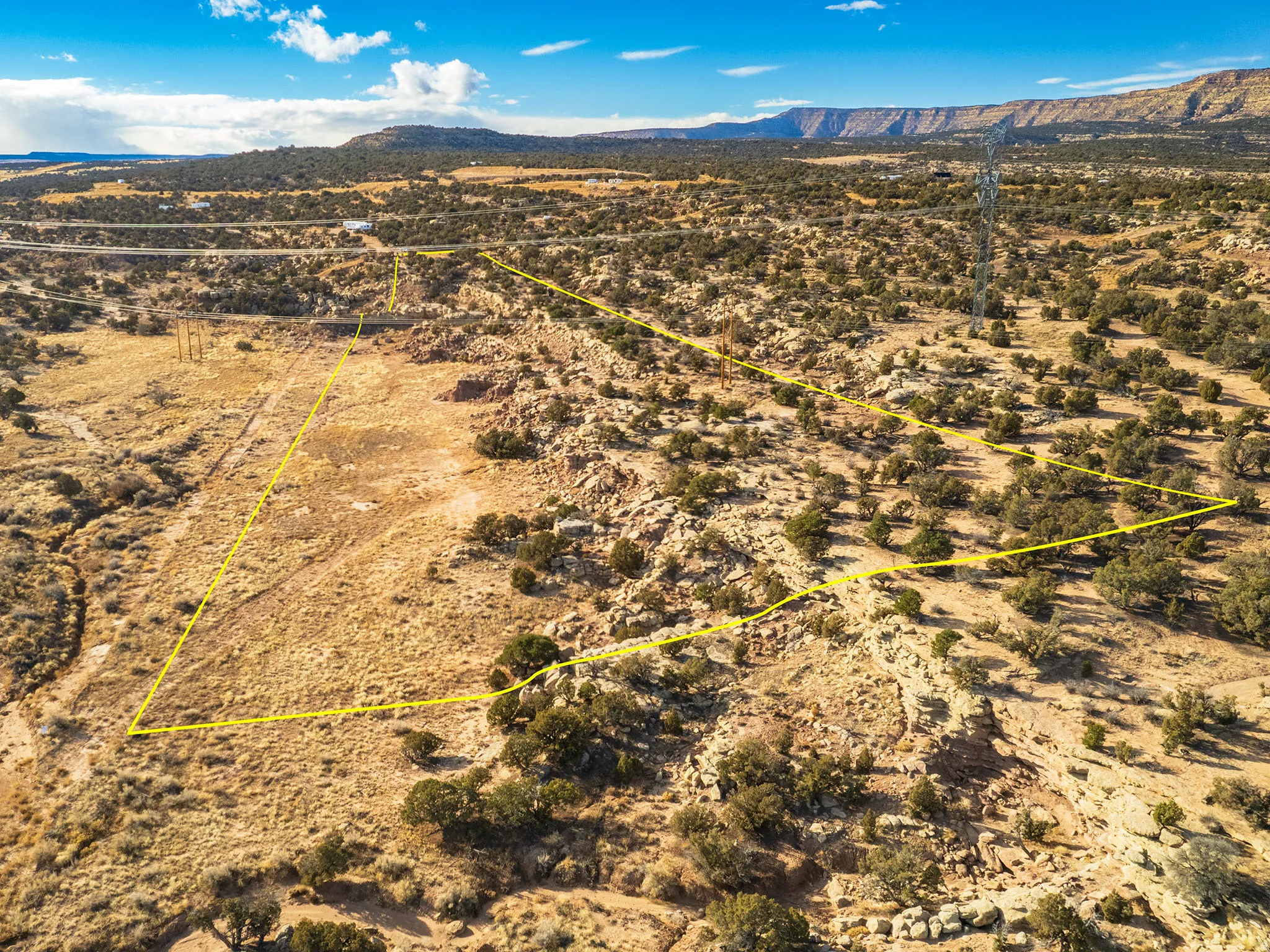 Aerial view of sparsely populated area featuring a mountainous background and a desert landscape