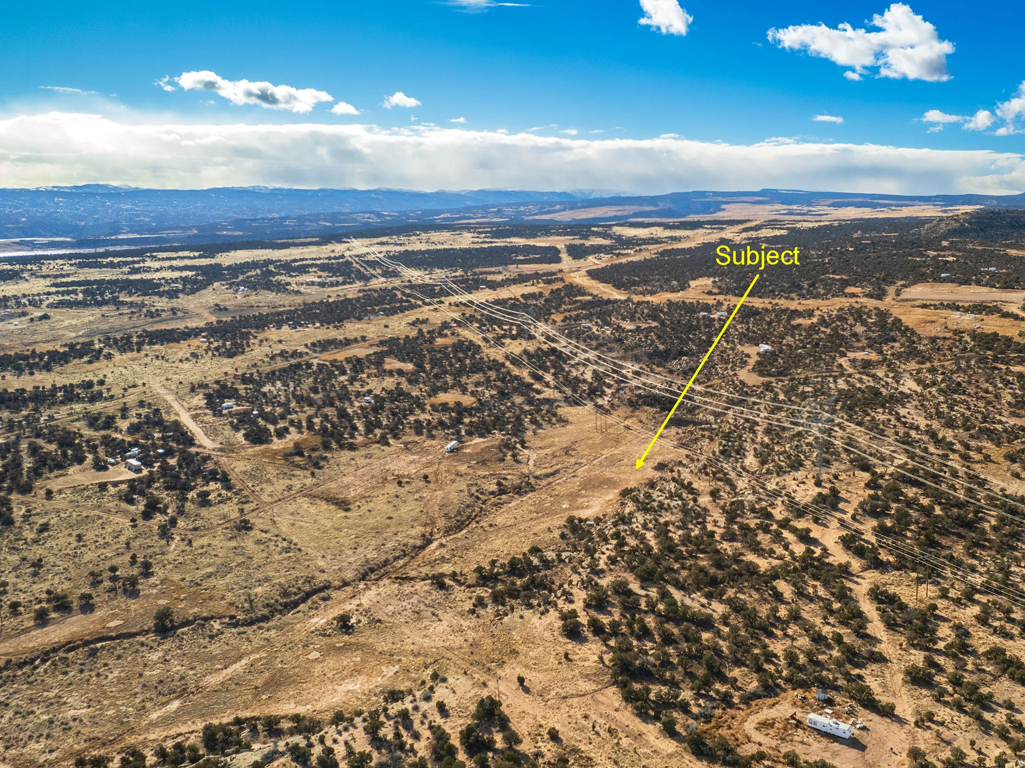 Overview of rural landscape featuring a mountainous background and a desert landscape
