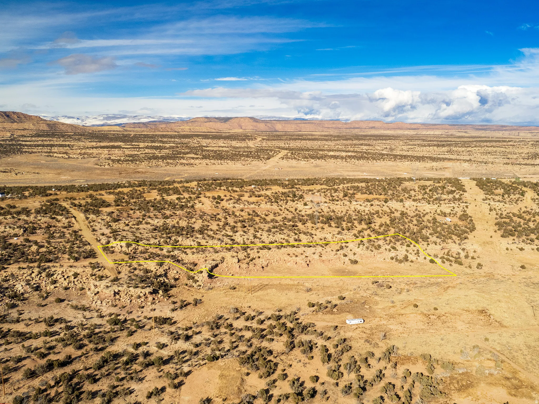 Aerial view of sparsely populated area with a desert landscape and a mountain backdrop