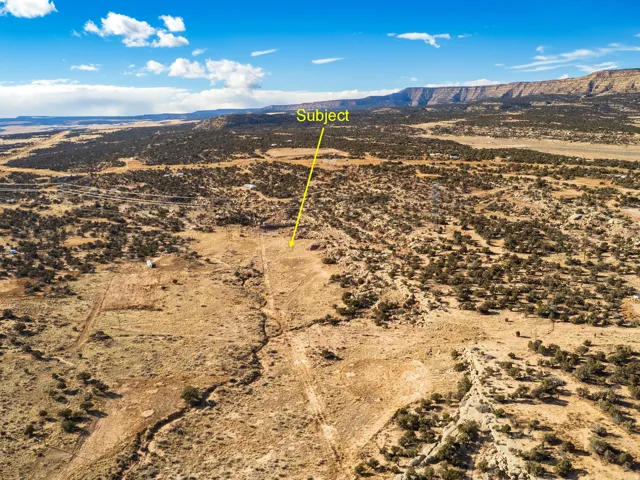 Aerial view of sparsely populated area featuring a mountainous background and a desert landscape