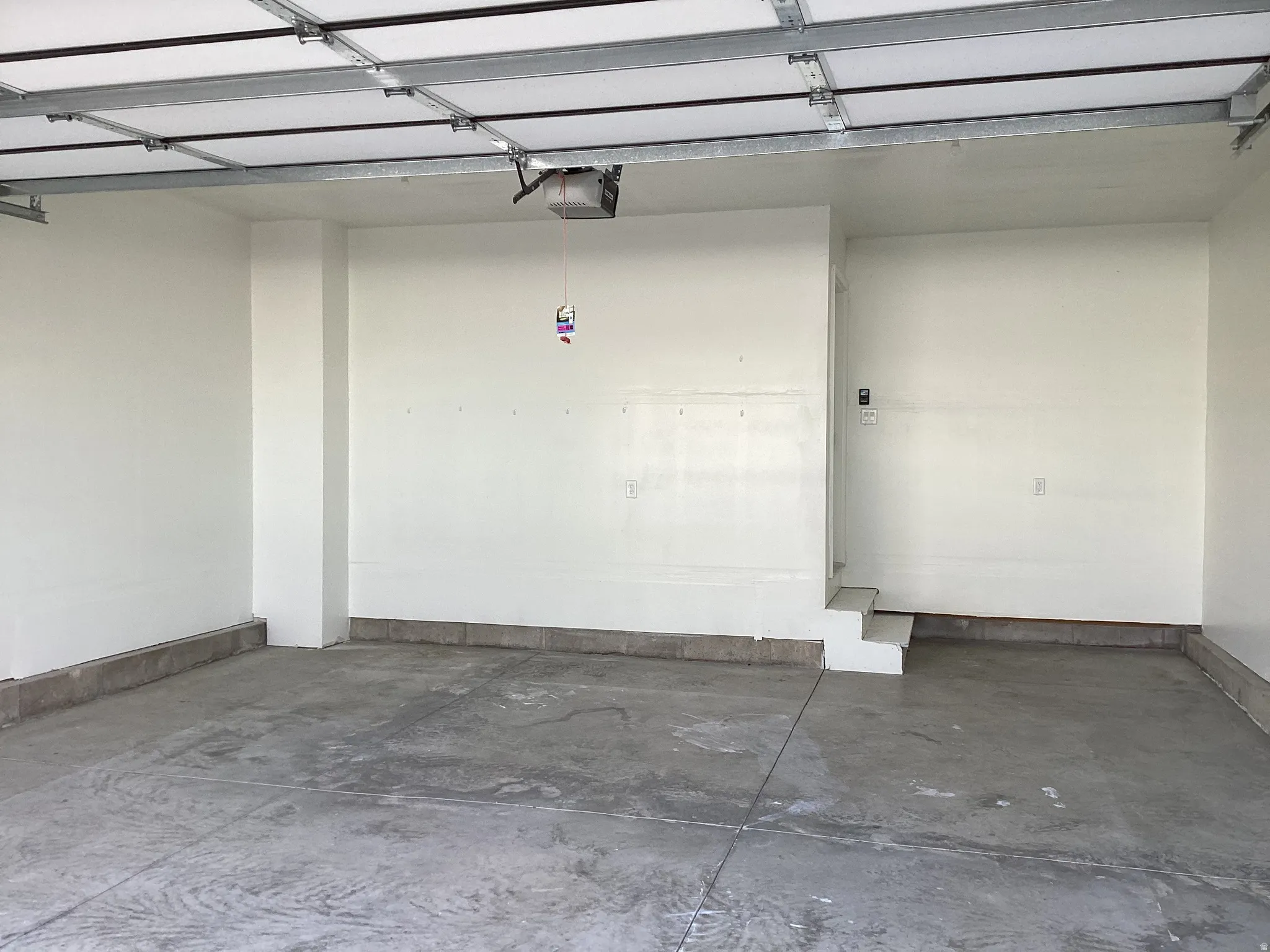 Parking garage with a garage door opener and baseboards