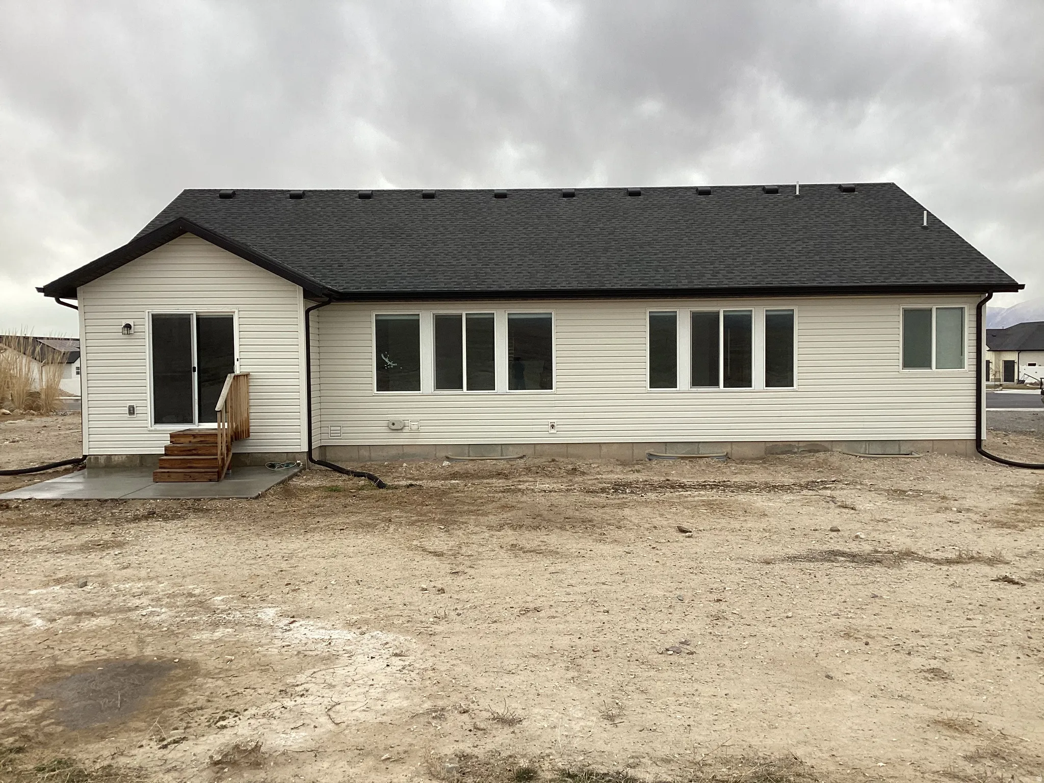 Rear view of property with a shingled roof and entry steps
