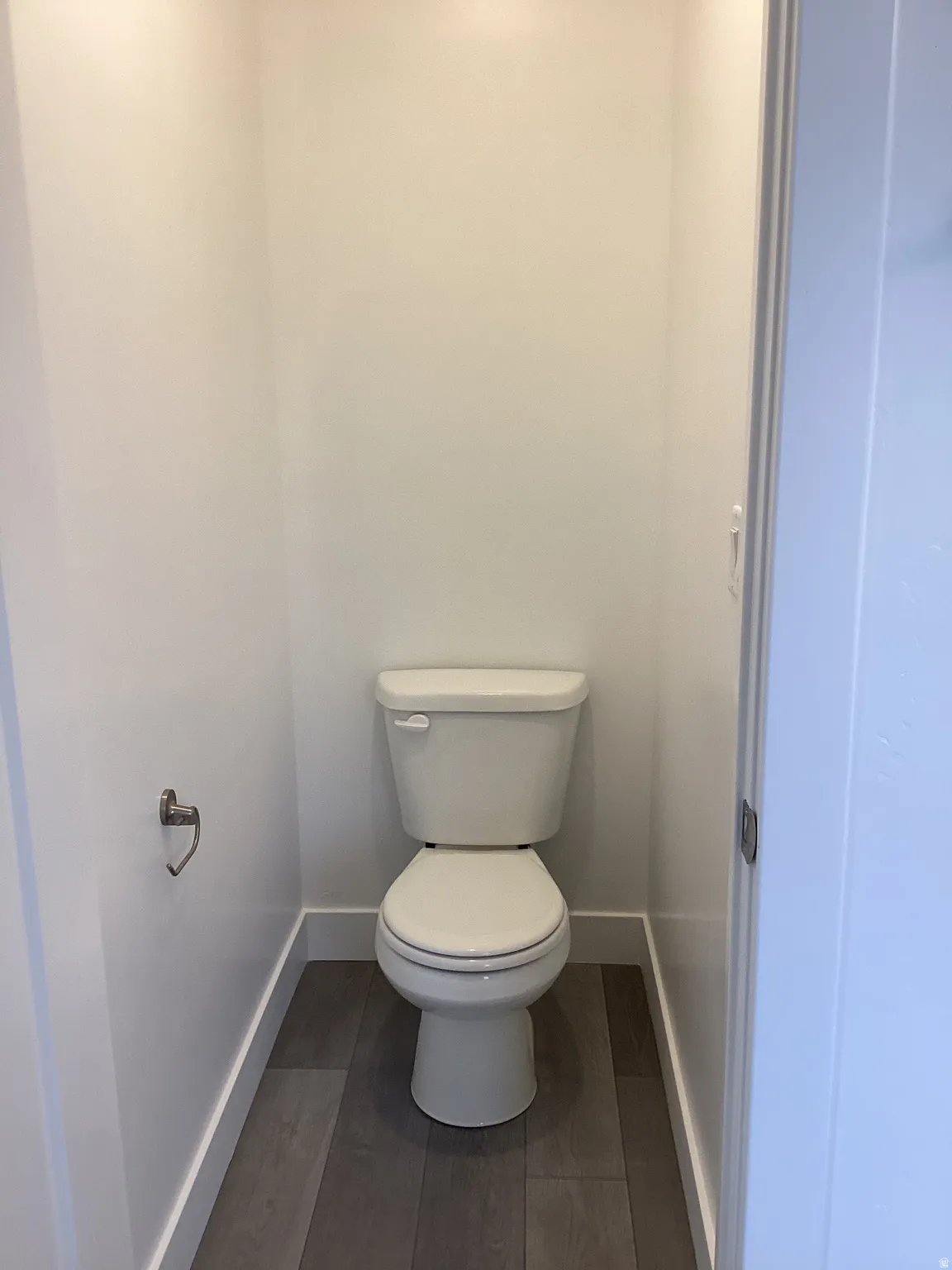 Bathroom with toilet and dark wood-style floors