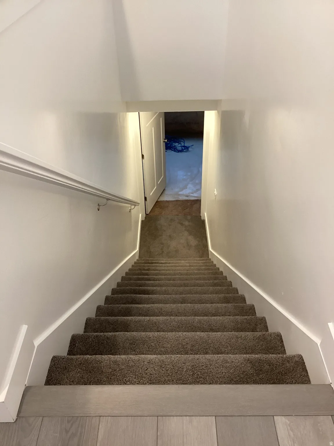 Stairs featuring carpet floors and baseboards