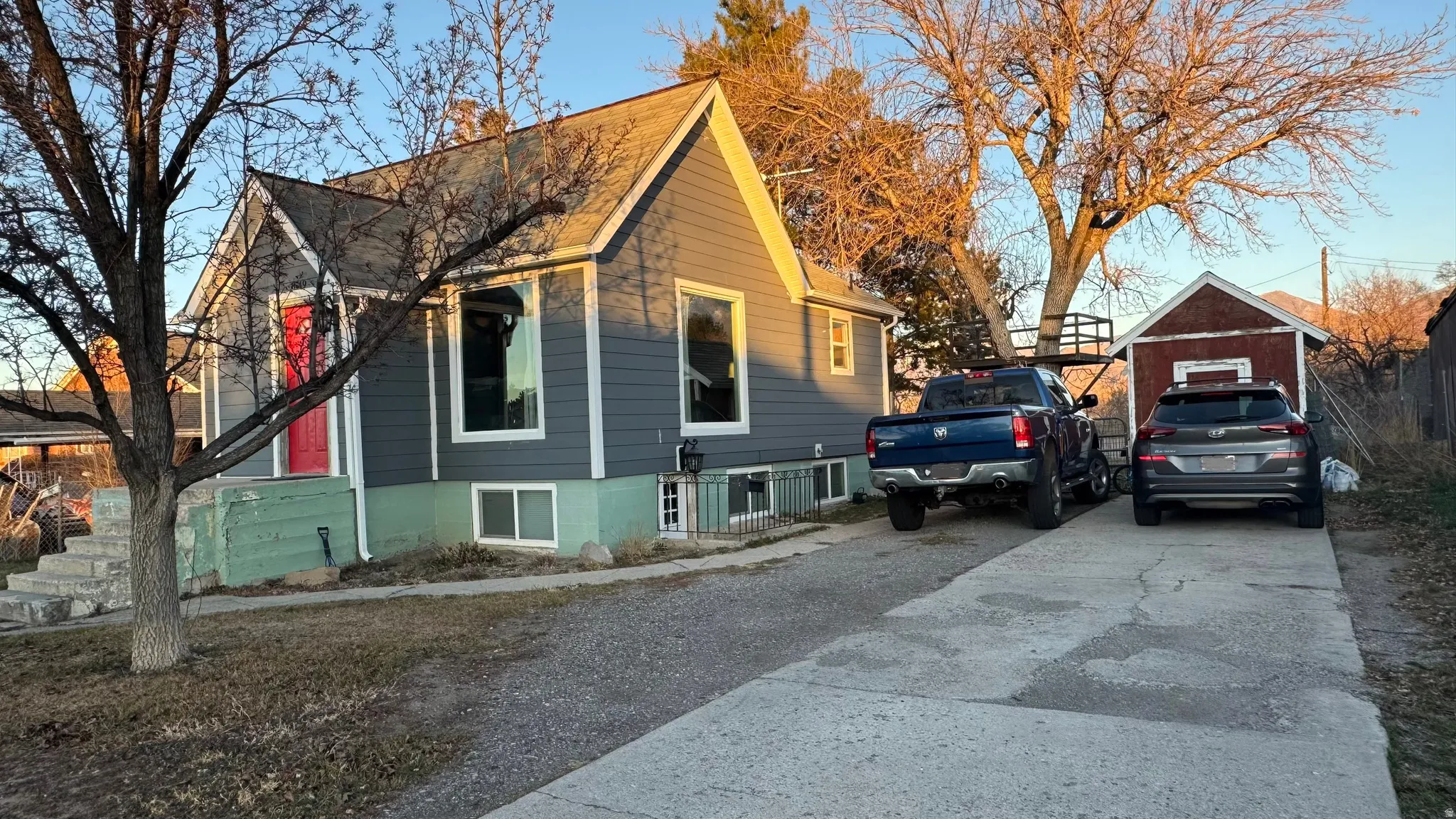 View of home's exterior featuring concrete driveway and an outdoor structure