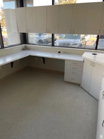 Unfurnished office featuring healthy amount of natural light and light floors