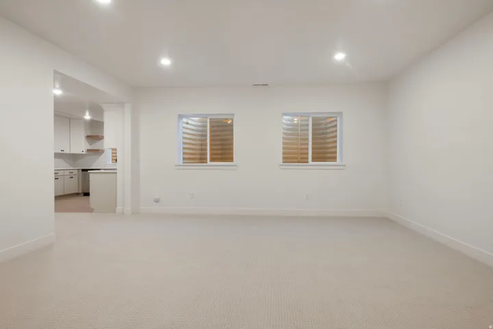 Unfurnished room with light colored carpet and recessed lighting