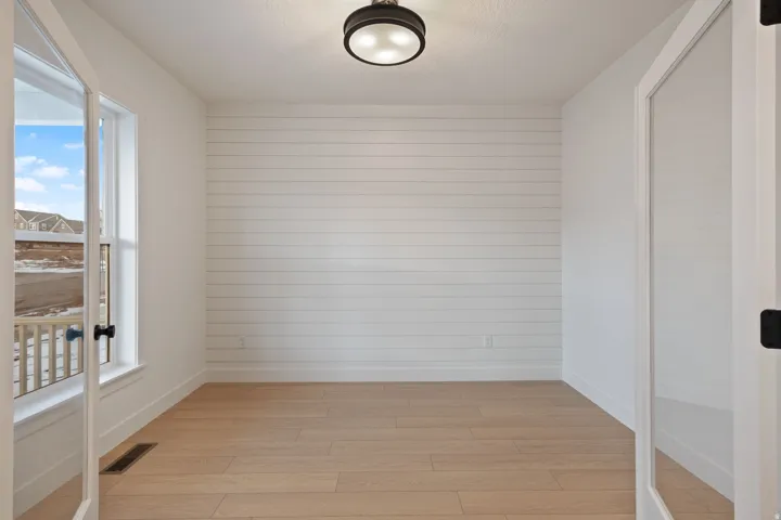 Empty room featuring light wood-type flooring and baseboards