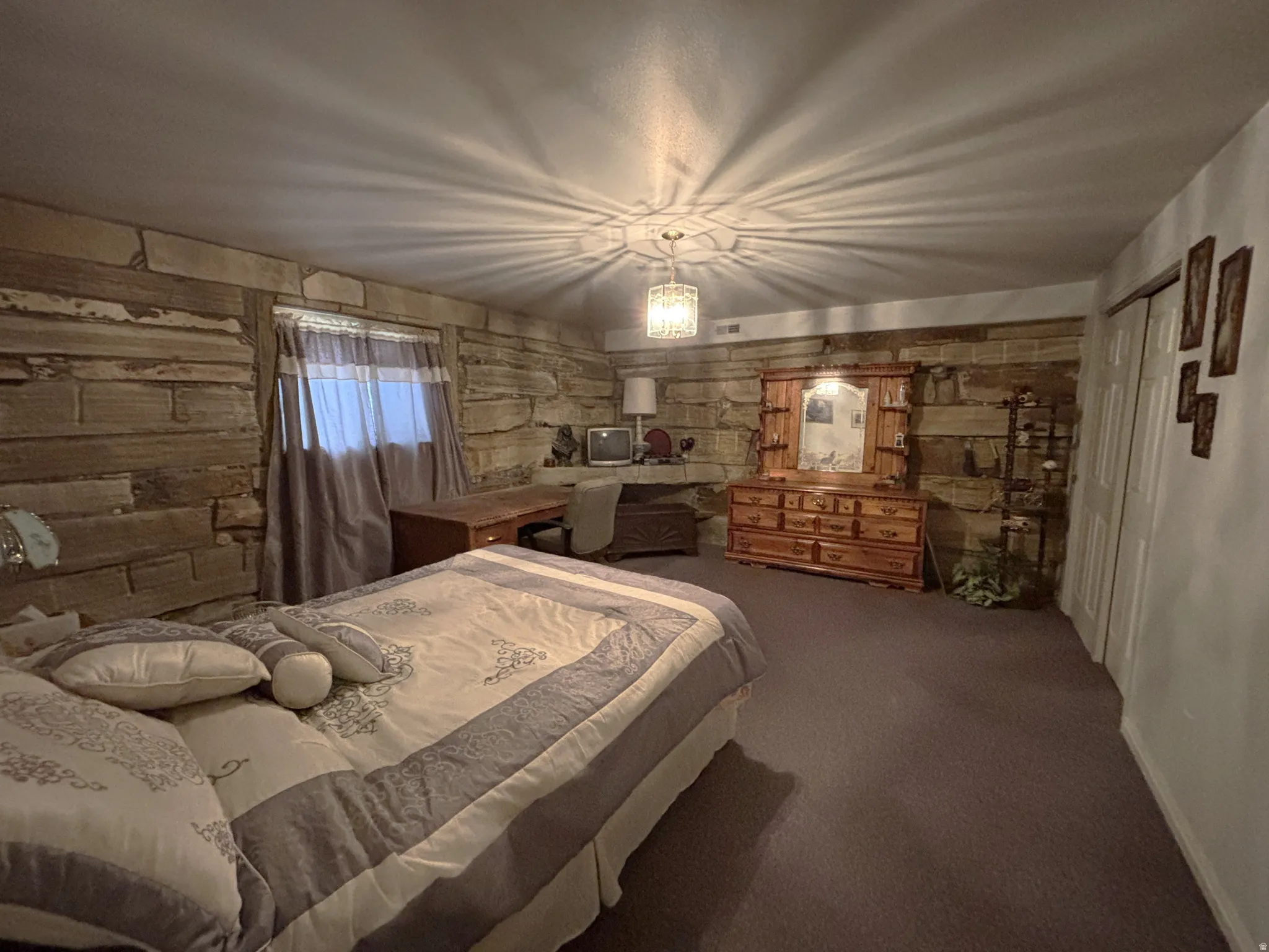 Carpeted bedroom with a closet