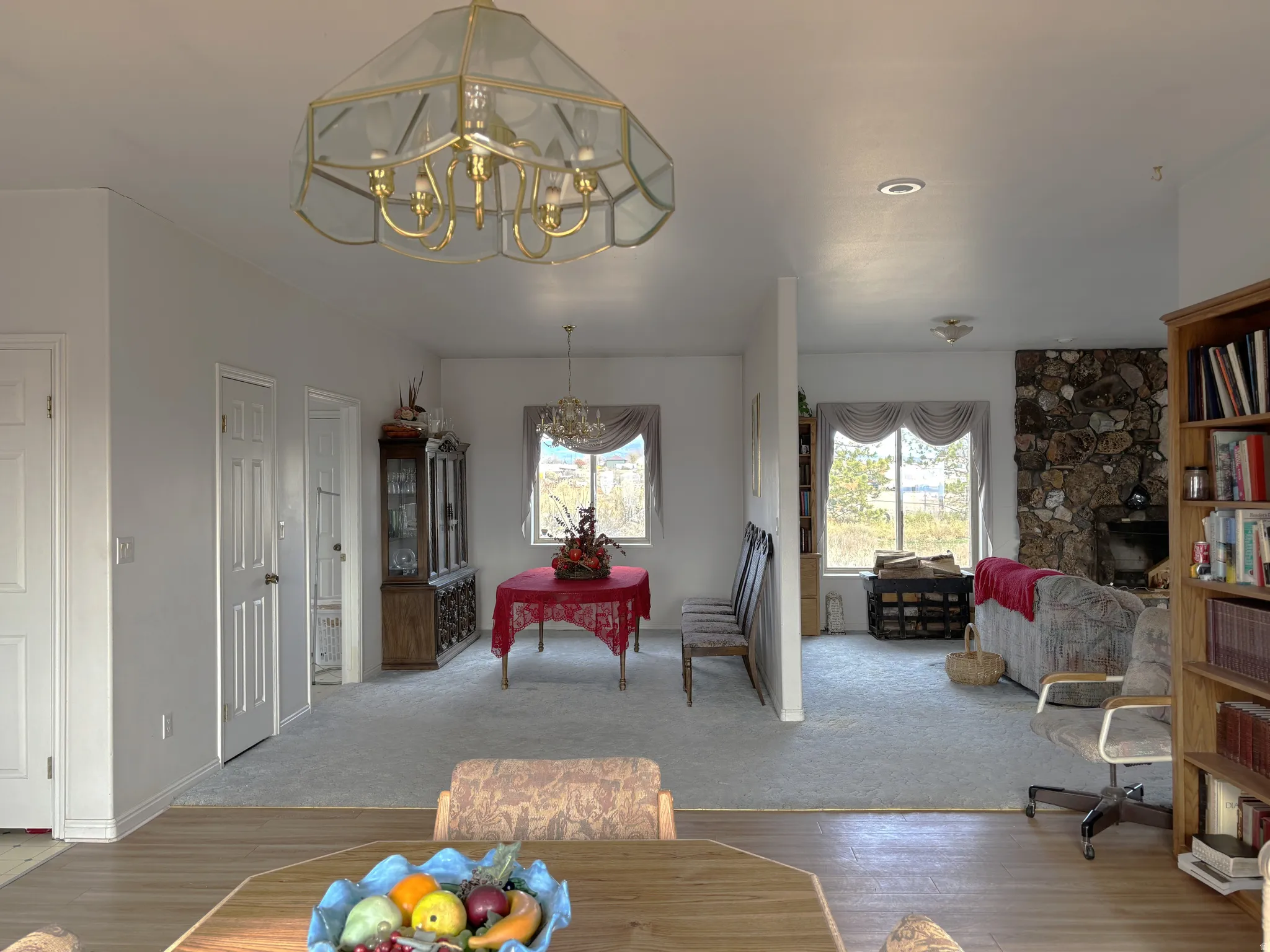 Dining space with wood finished floors, plenty of natural light, and a chandelier