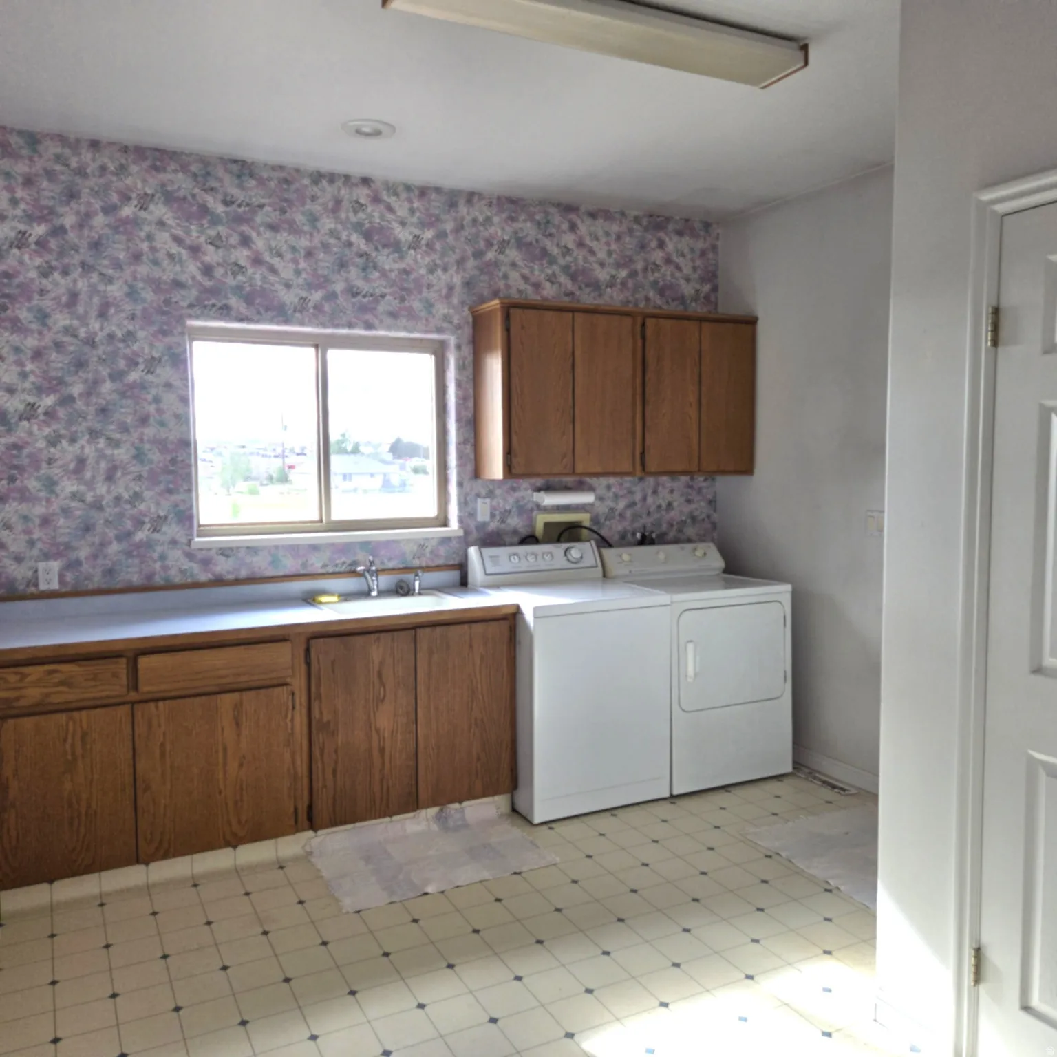 Laundry room featuring cabinet space, separate washer and dryer, and light flooring