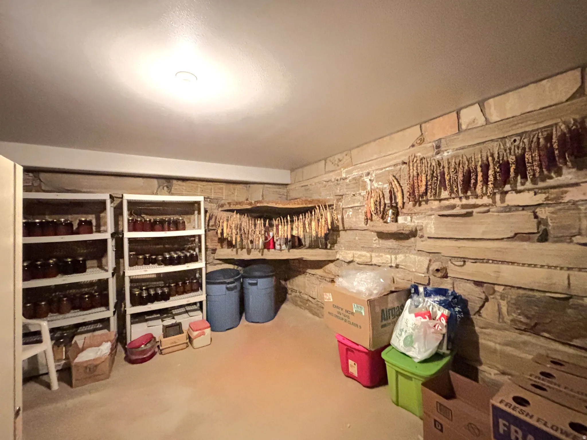 View of storage area with stone niches and shelves built in.
