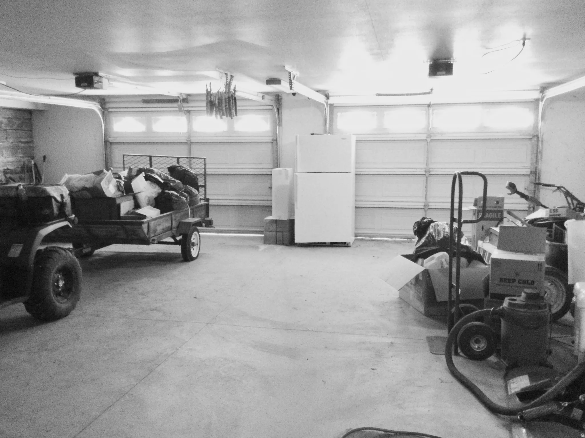 Extra wide garage with stone walls and extra storage closet.