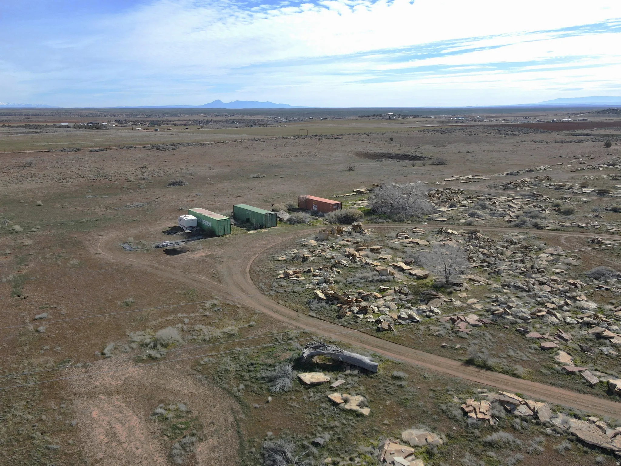 One container is included. Aerial view of property's location featuring rural landscape and mountains