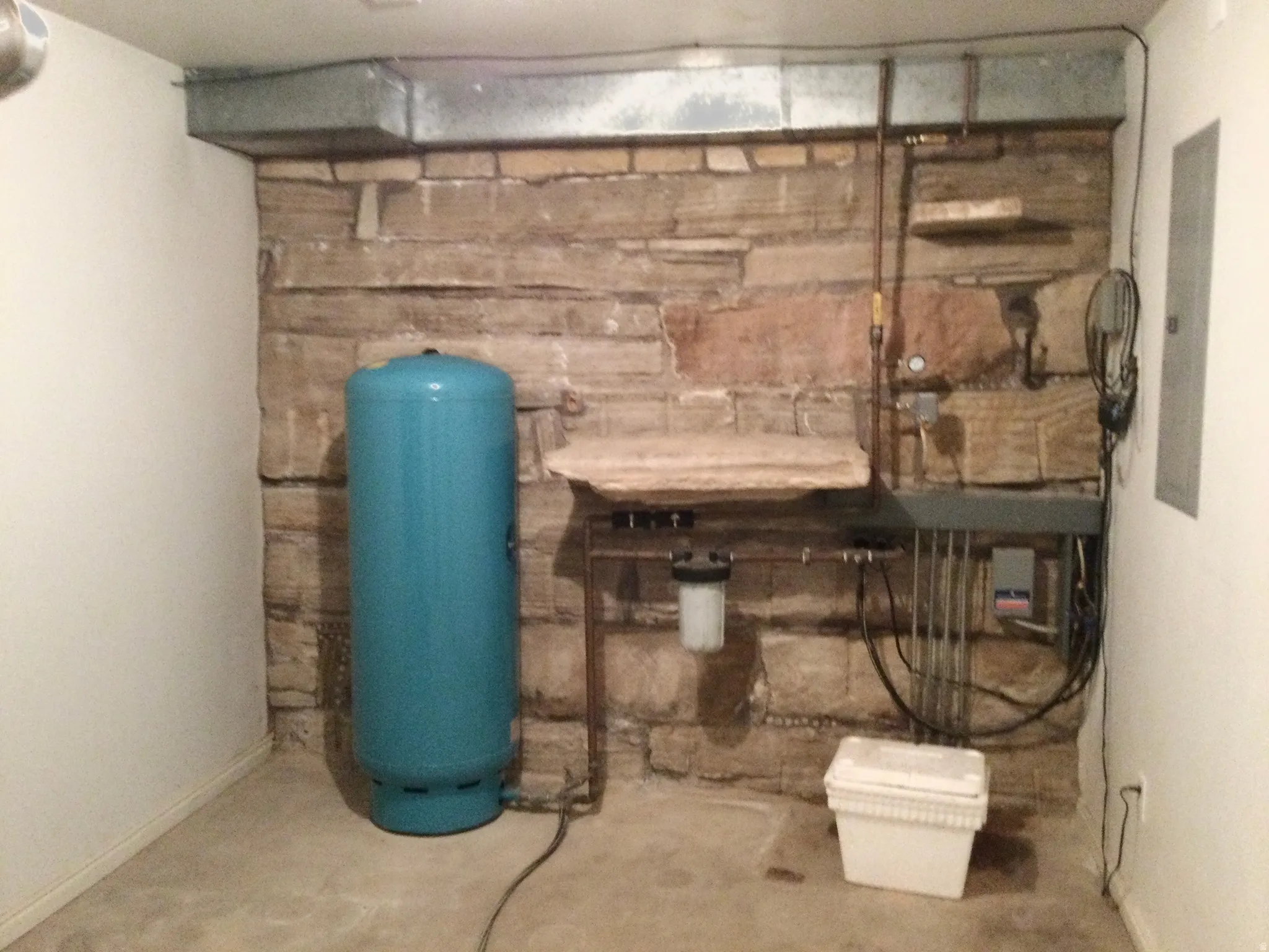 Utility room, pressure tank and built in shelves.