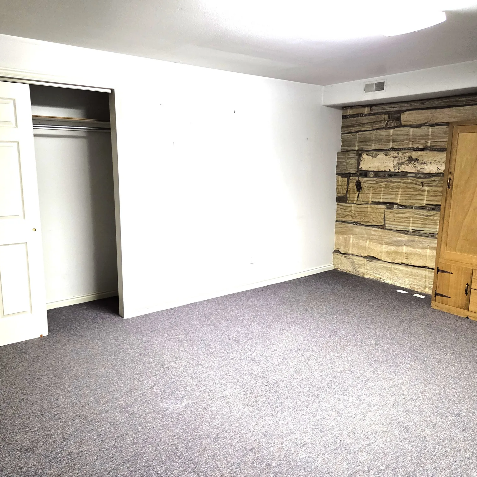 Unfurnished bedroom featuring carpet flooring and a closet
