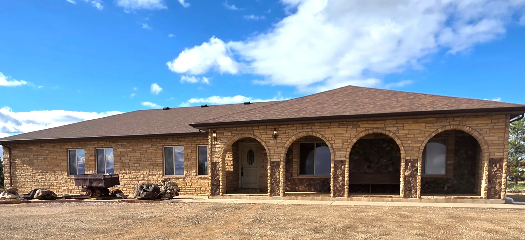 View of front of home featuring a shingled roof