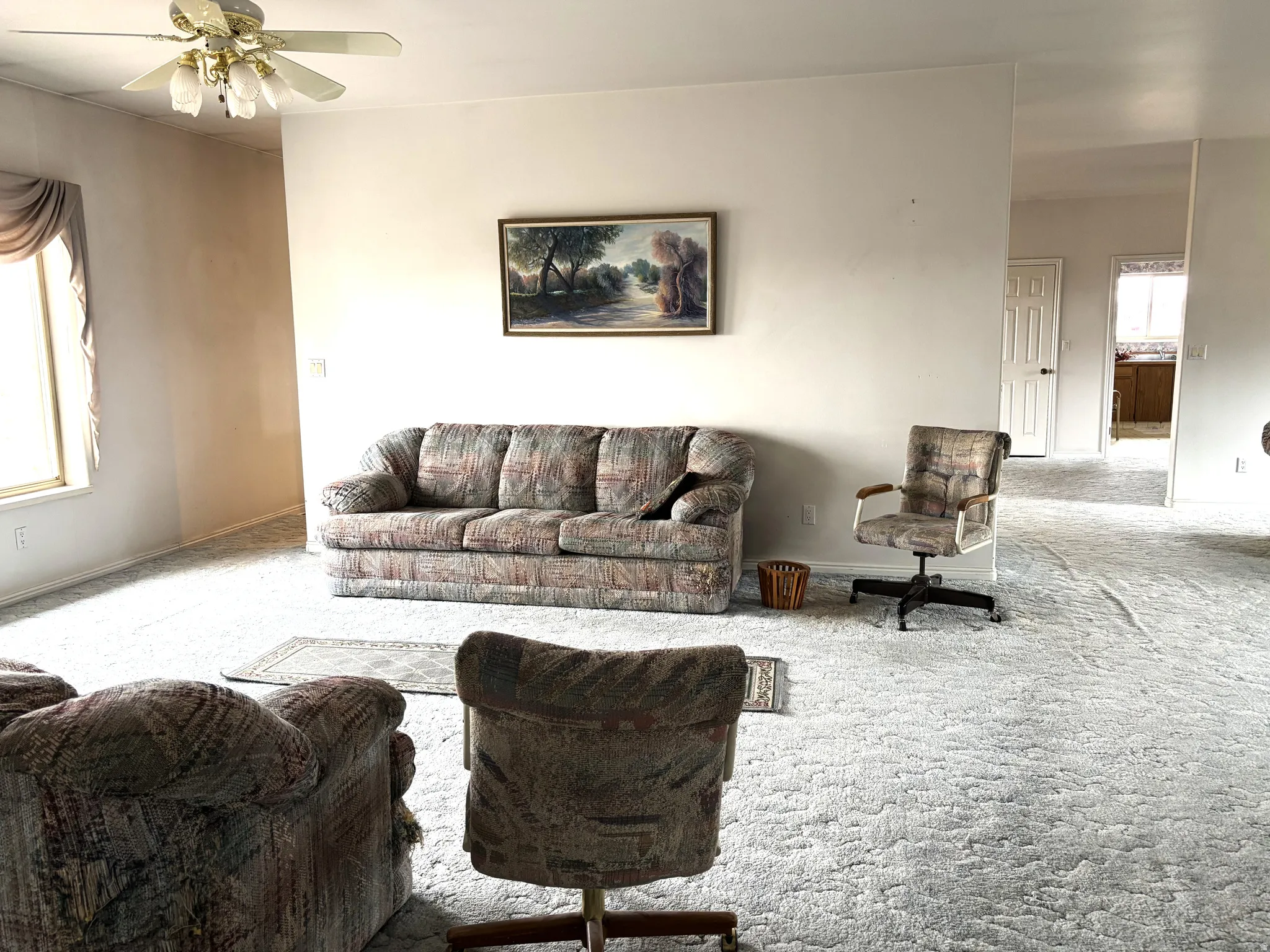 Living room featuring carpet flooring and ceiling fan