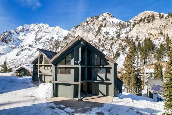 Front of home with a mountain view and a garage