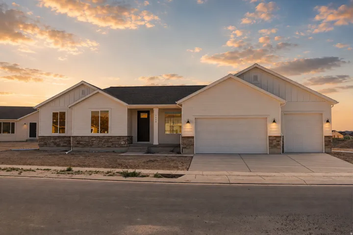 Contemporary ranch-style exterior featuring white horizontal siding and vertical board and batten accents