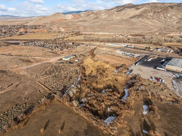 Aerial view of property's location with a mountain backdrop and rural landscape