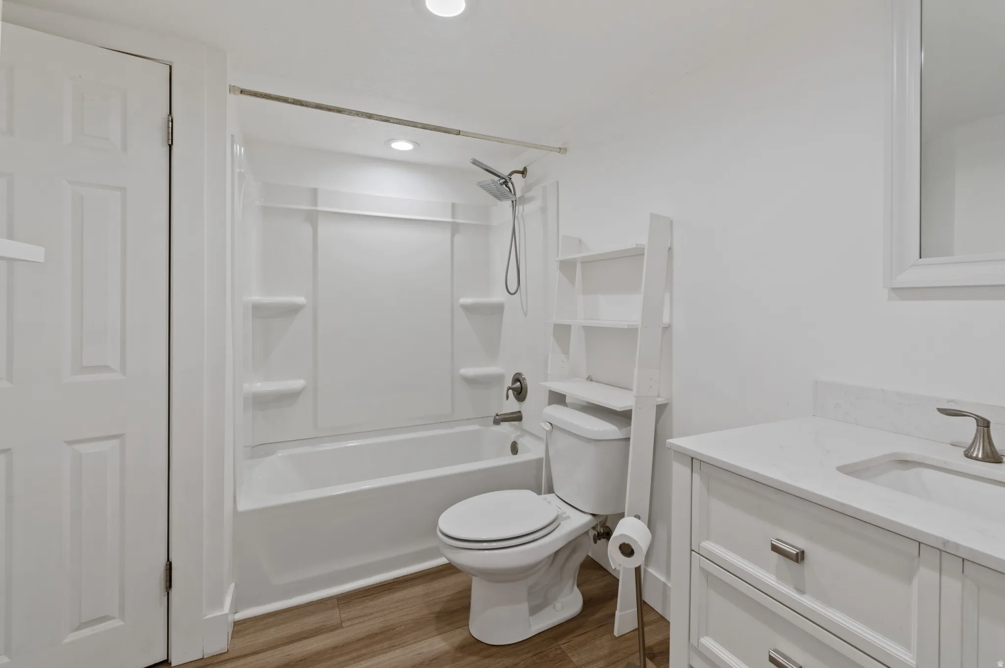Full bath with vanity, shower / tub combination, light wood-style floors, and recessed lighting