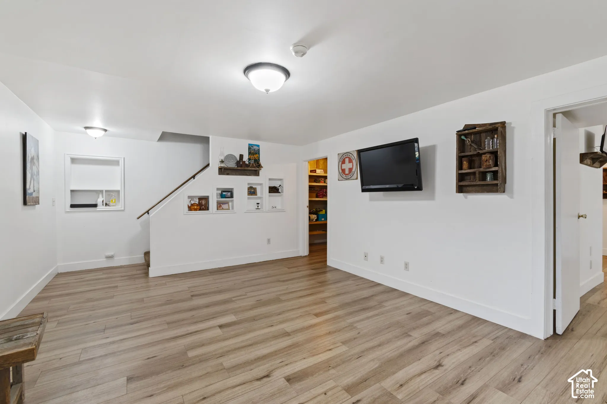 Finished below grade area featuring light wood-style floors and baseboards