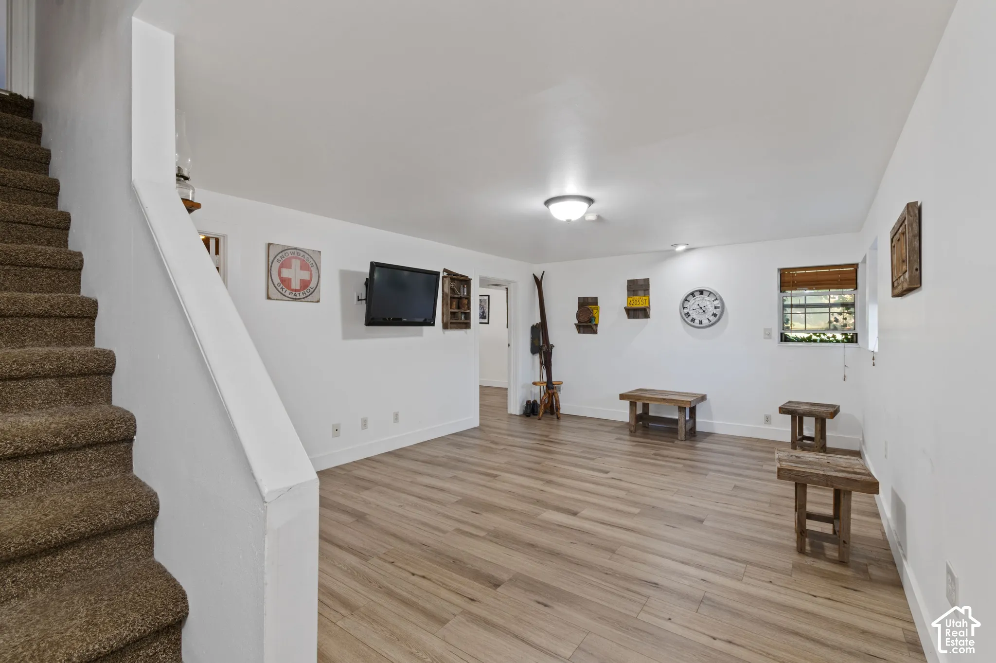 Living area featuring stairway and light wood-style flooring