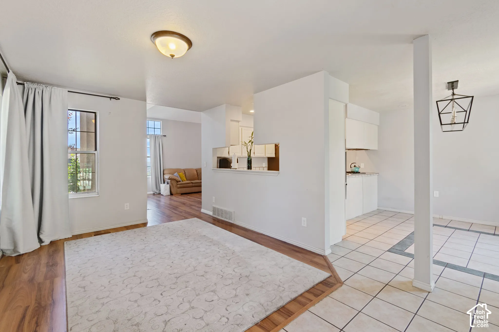 Empty room featuring baseboards and light tile patterned flooring