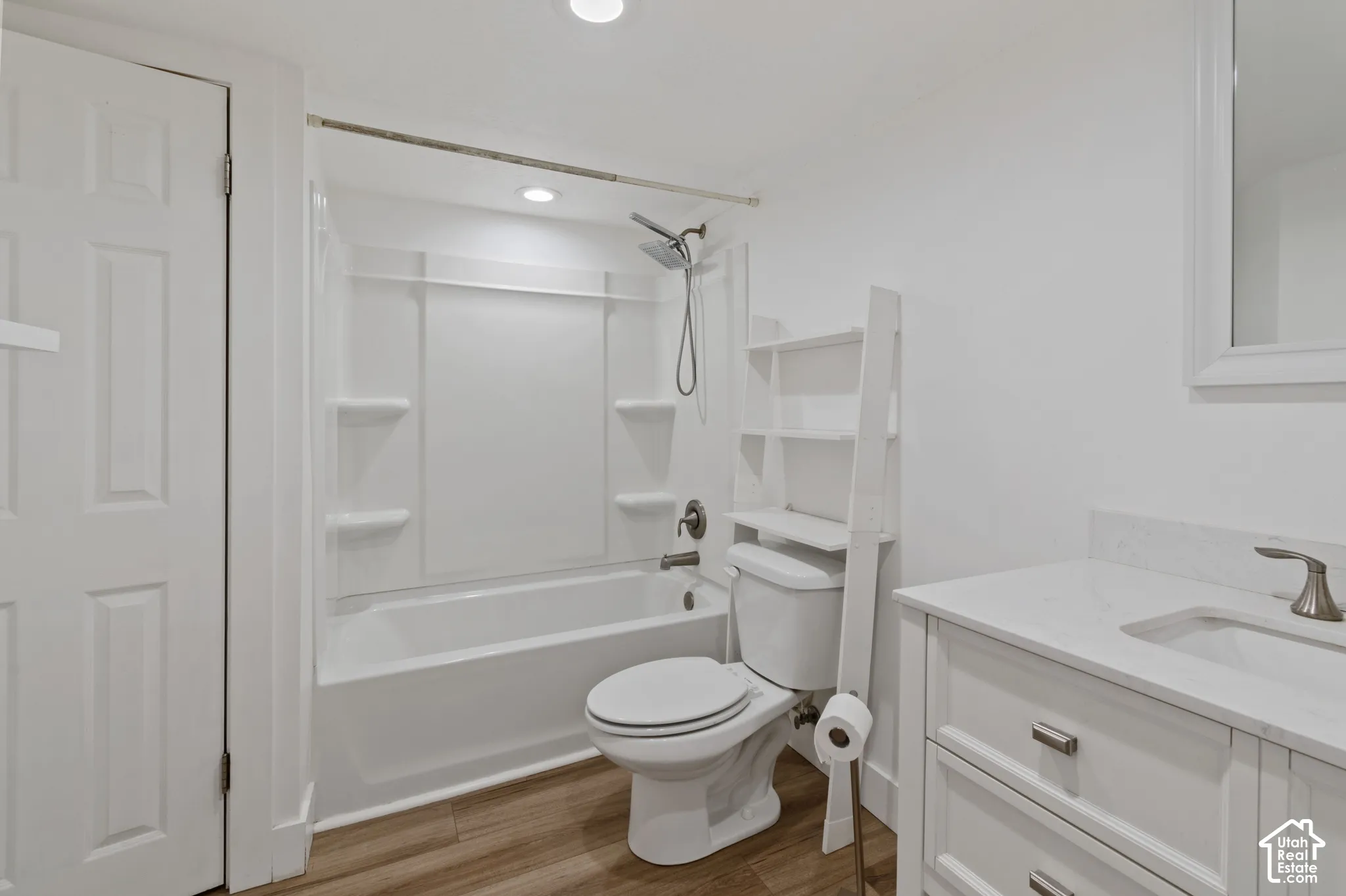 Full bath with vanity, shower / tub combination, light wood-style floors, and recessed lighting