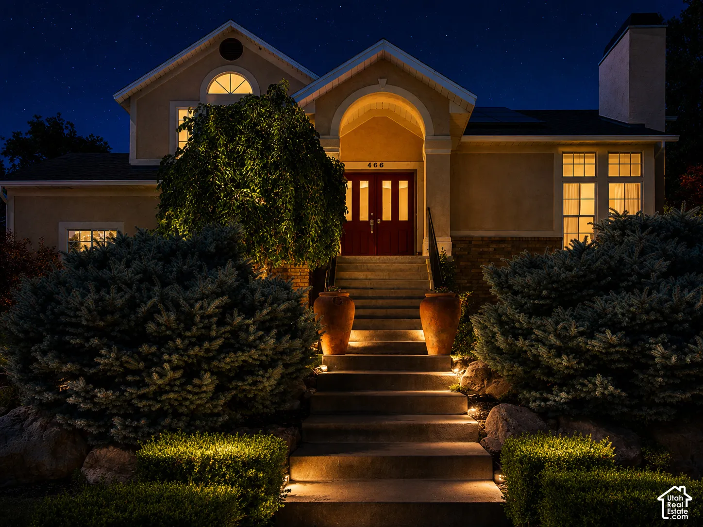 Stucco-finish exterior with a prominent arched entry