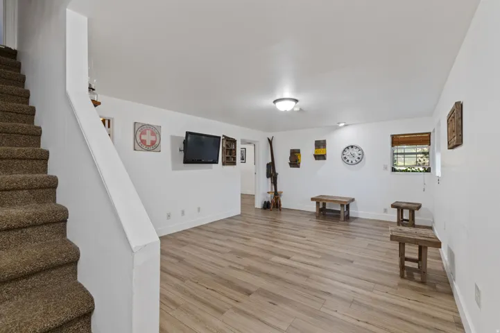 Living area featuring stairway and light wood-style flooring