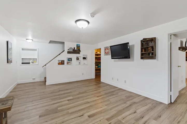 Finished below grade area featuring light wood-style floors and baseboards