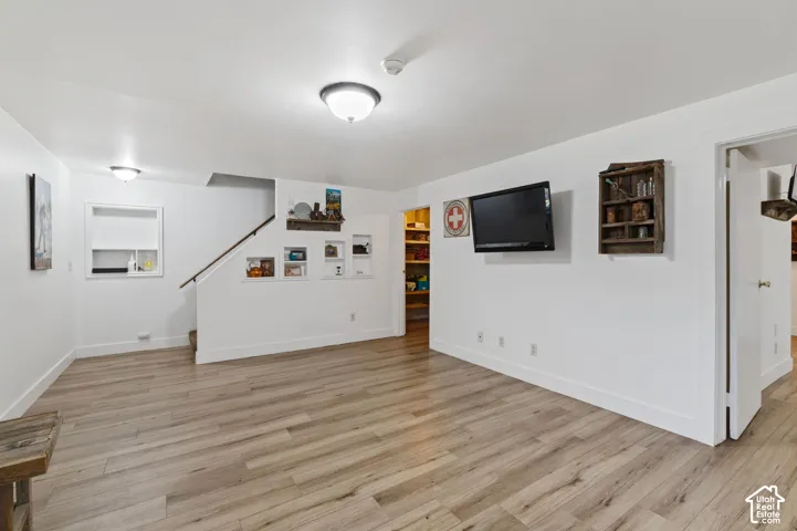 Finished below grade area featuring light wood-style floors and baseboards