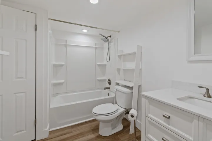 Full bath with vanity, shower / tub combination, light wood-style floors, and recessed lighting
