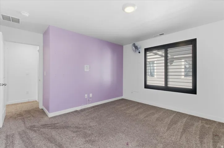 Carpeted bedroom with baseboards