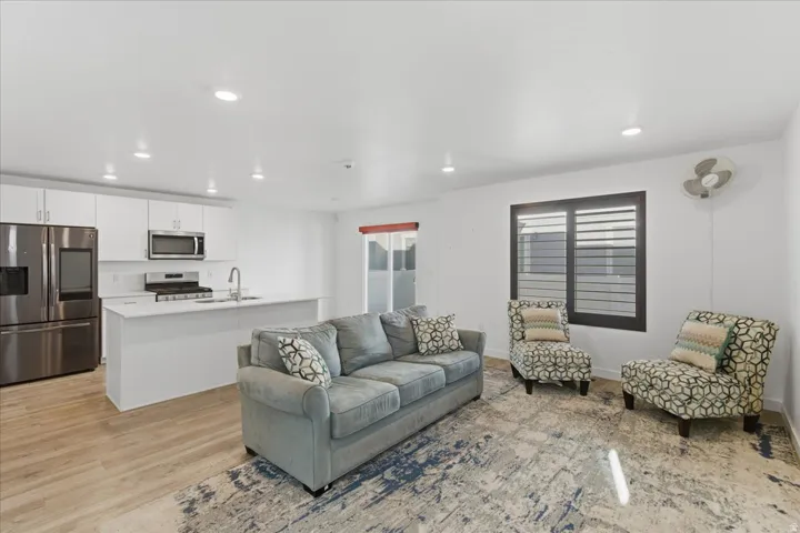 Living room with recessed lighting and light wood-style flooring