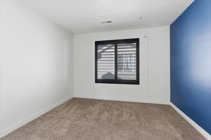Carpeted bedroom with baseboards