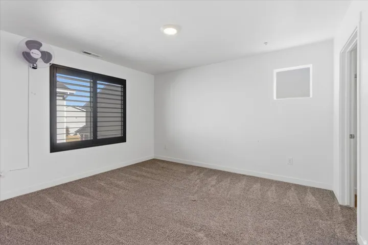 Bedroom with carpet floors and baseboards