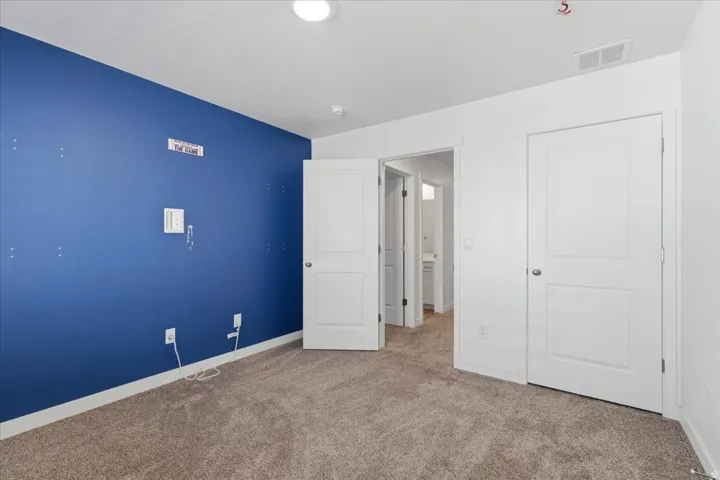 Bedroom featuring carpet floors and baseboards