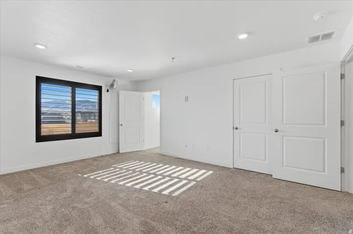Bedroom featuring baseboards and carpet