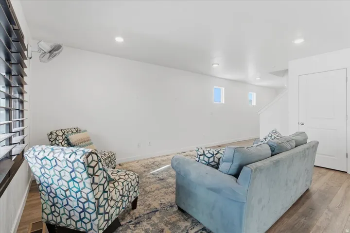 Living area featuring wood finished floors and recessed lighting