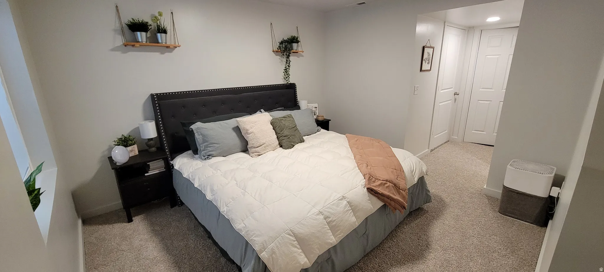 Finished Basement Family Room currently being used as a Bedroom with brand new light colored carpet