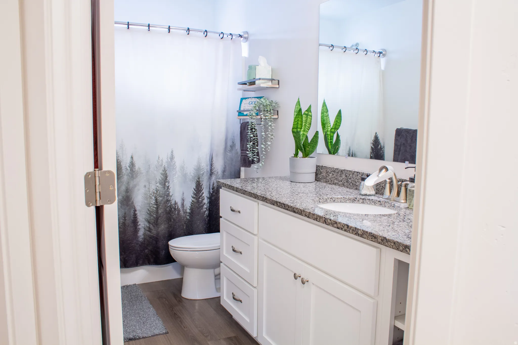 Bathroom with a shower with shower curtain, vanity, and dark wood-style floors
