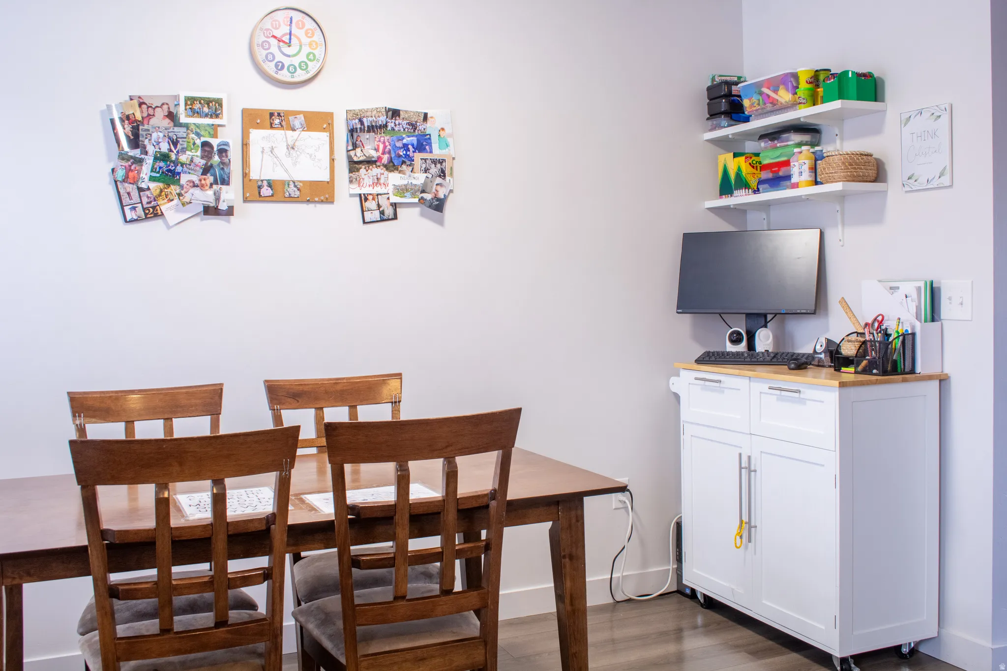 Dining space featuring dark wood-type flooring and baseboards