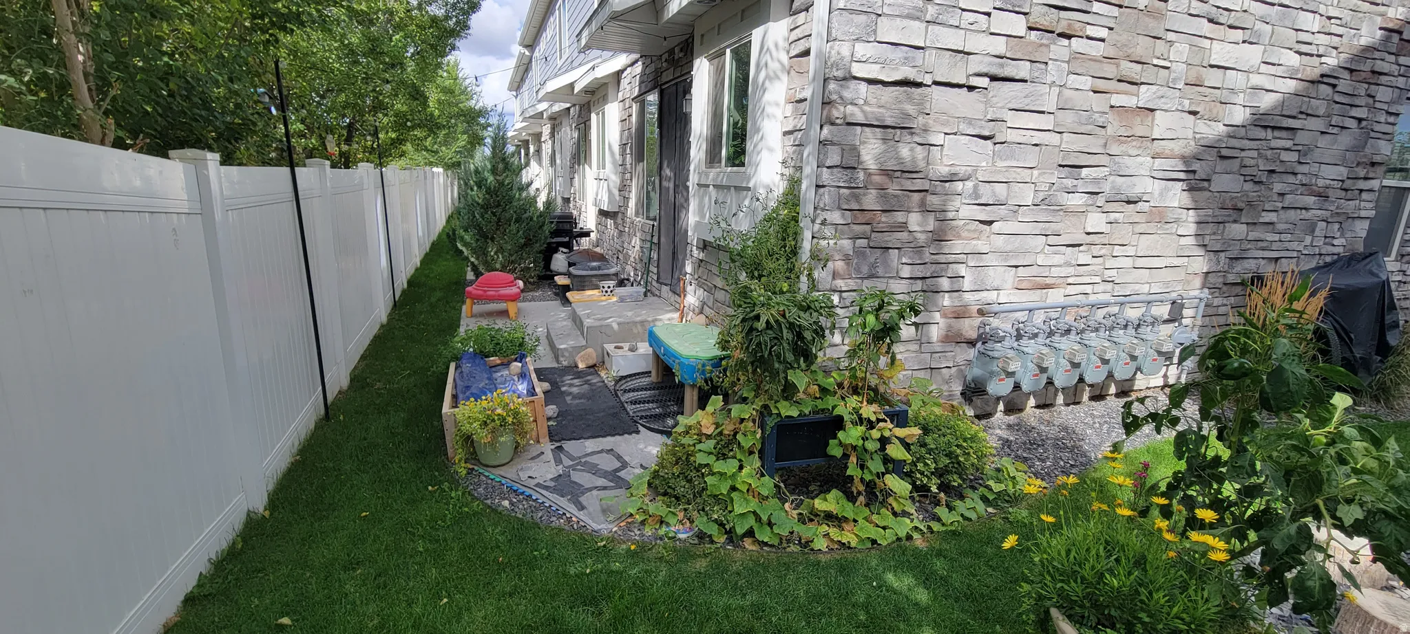 View of partially fenced backyard and a patio