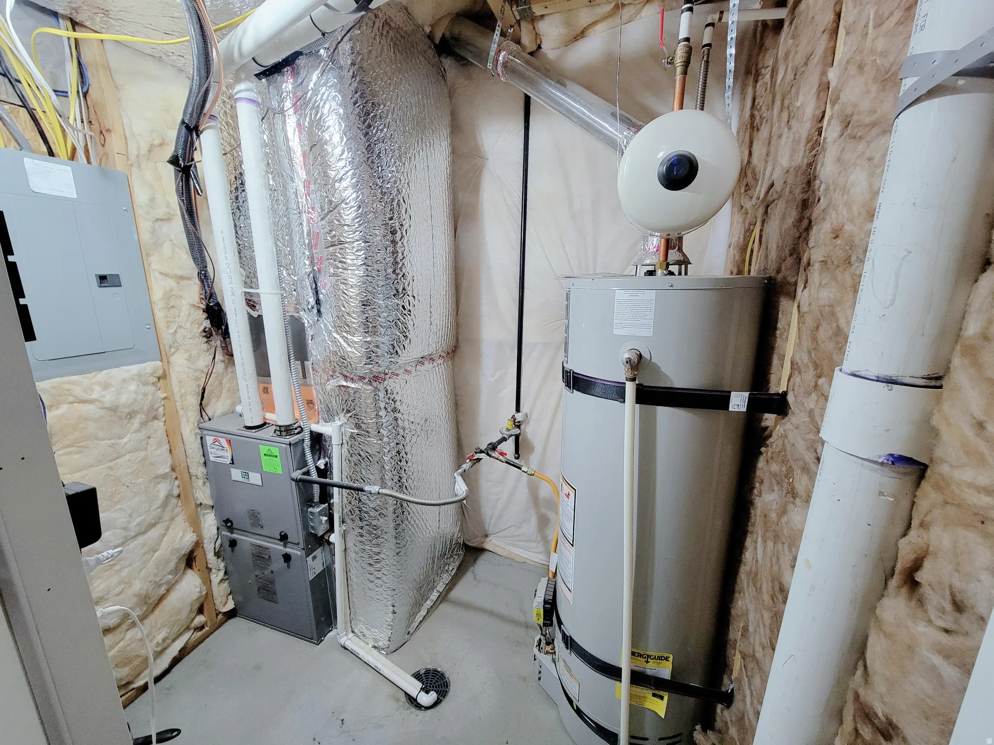 Utilities featuring water heater, heating unit, and electric panel