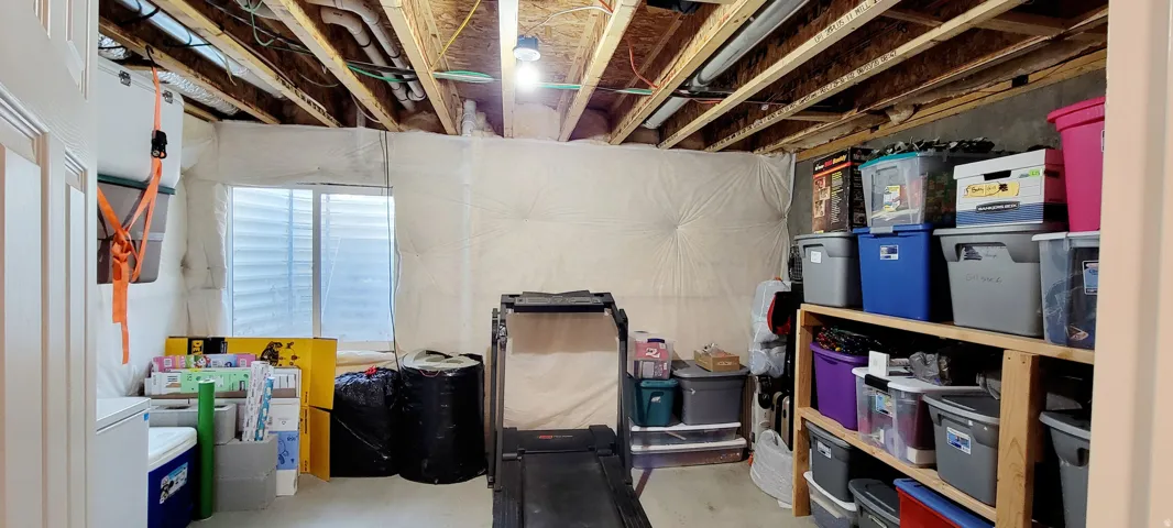 View of storage area in basement.  Plumbed for another bathroom.